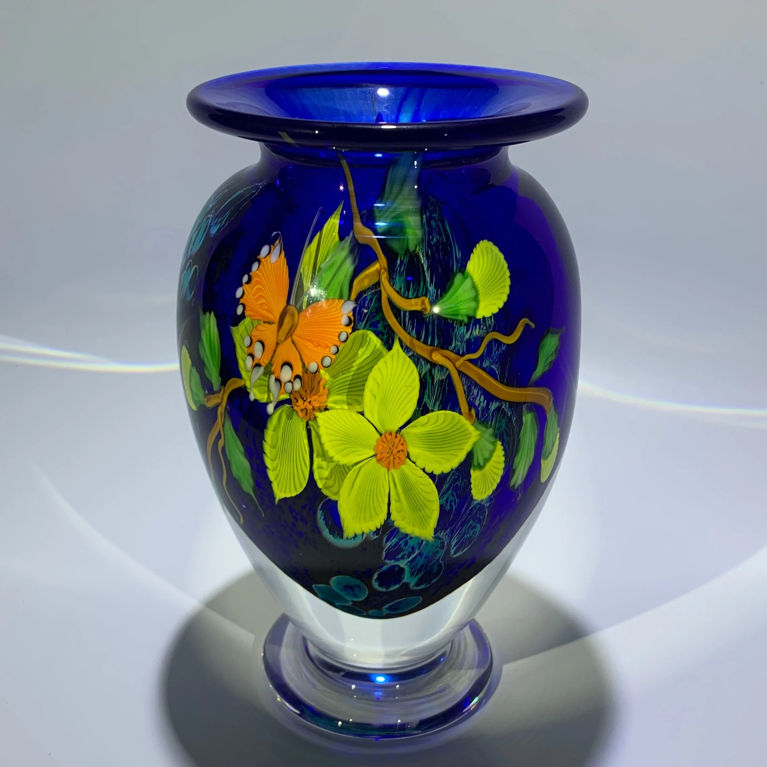 Mayauel Ward 2019 Compound Torchwork Orange Swallowtail Butterfly with Yellow Blossoms on Blue