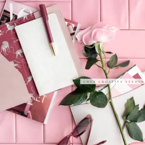 Pink Rose & Notebook on Pink Background. Stock Photo