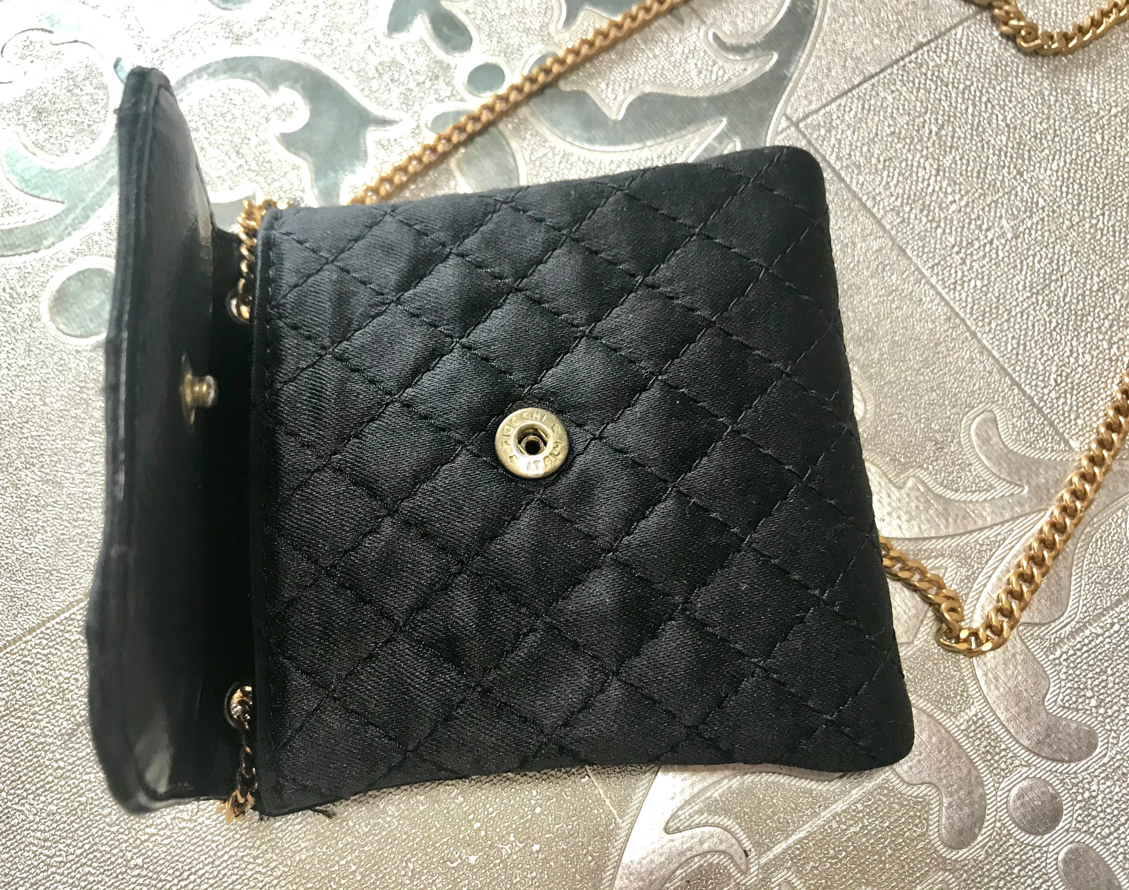 Vintage Chanel black quilted satin fabric mini pouch, coin purse, long necklace with golden chain and CC motif. Fiocci snap. 060516re2