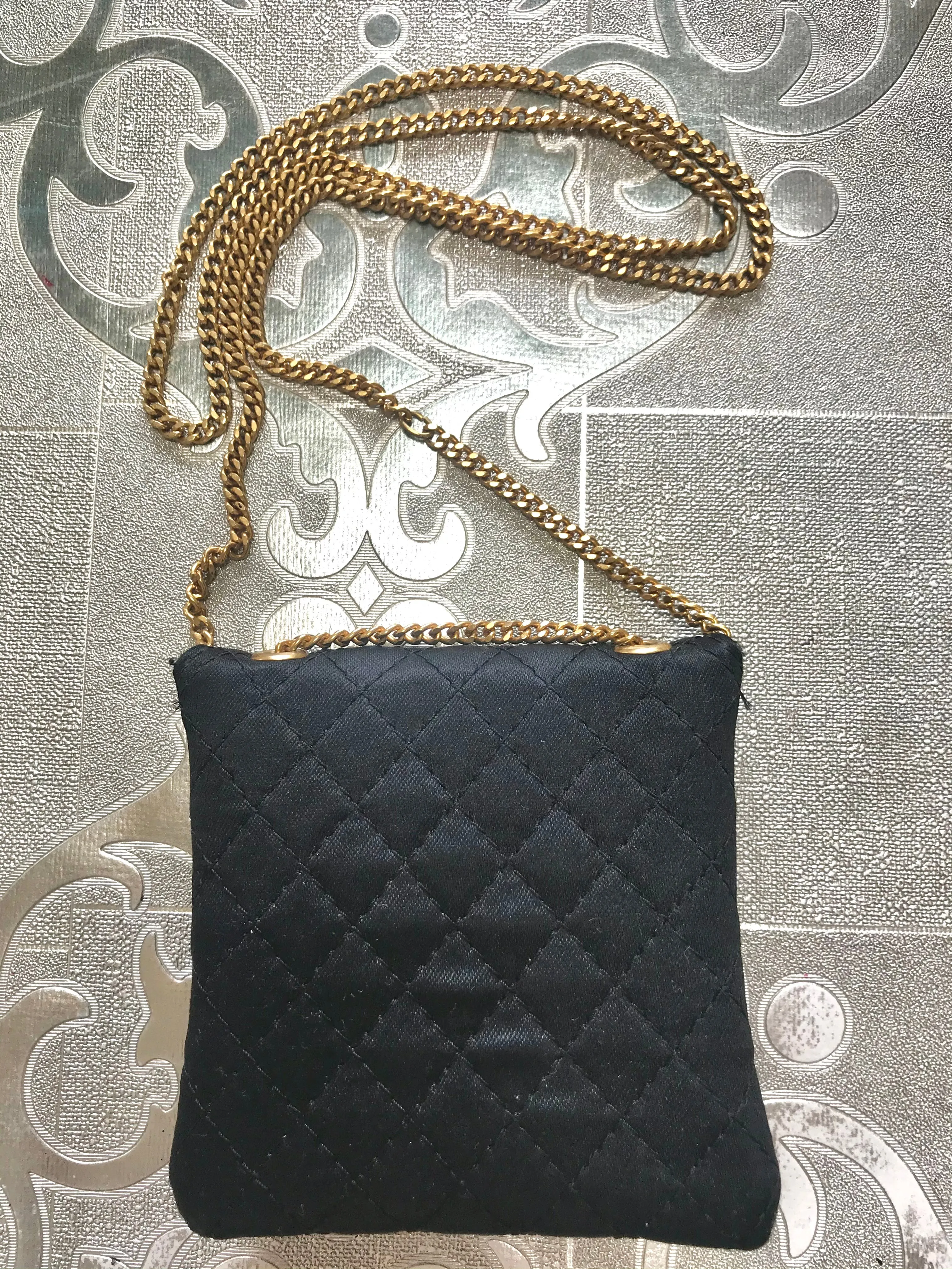 Vintage Chanel black quilted satin fabric mini pouch, coin purse, long necklace with golden chain and CC motif. Fiocci snap. 060516re2