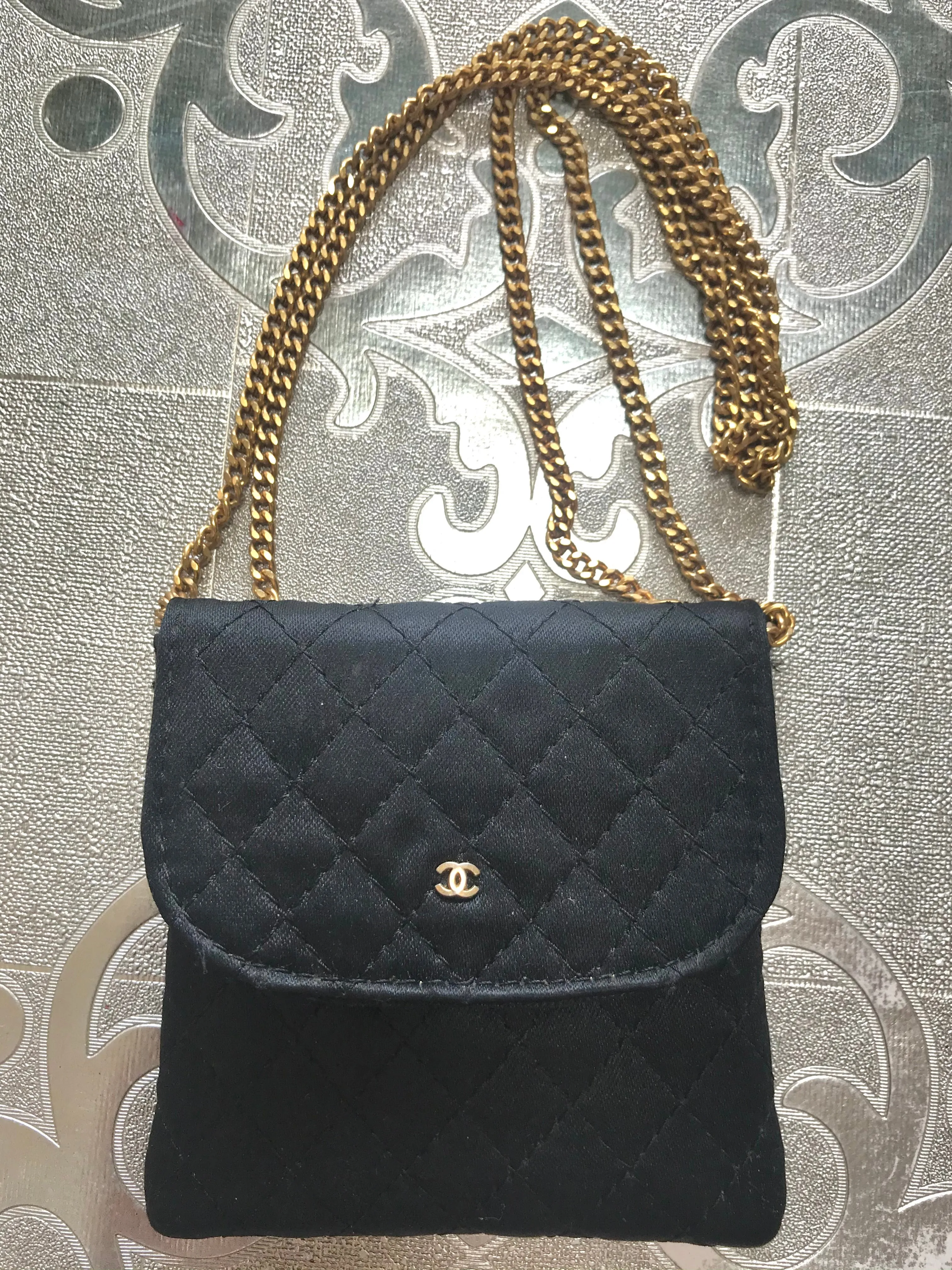 Vintage Chanel black quilted satin fabric mini pouch, coin purse, long necklace with golden chain and CC motif. Fiocci snap. 060516re2