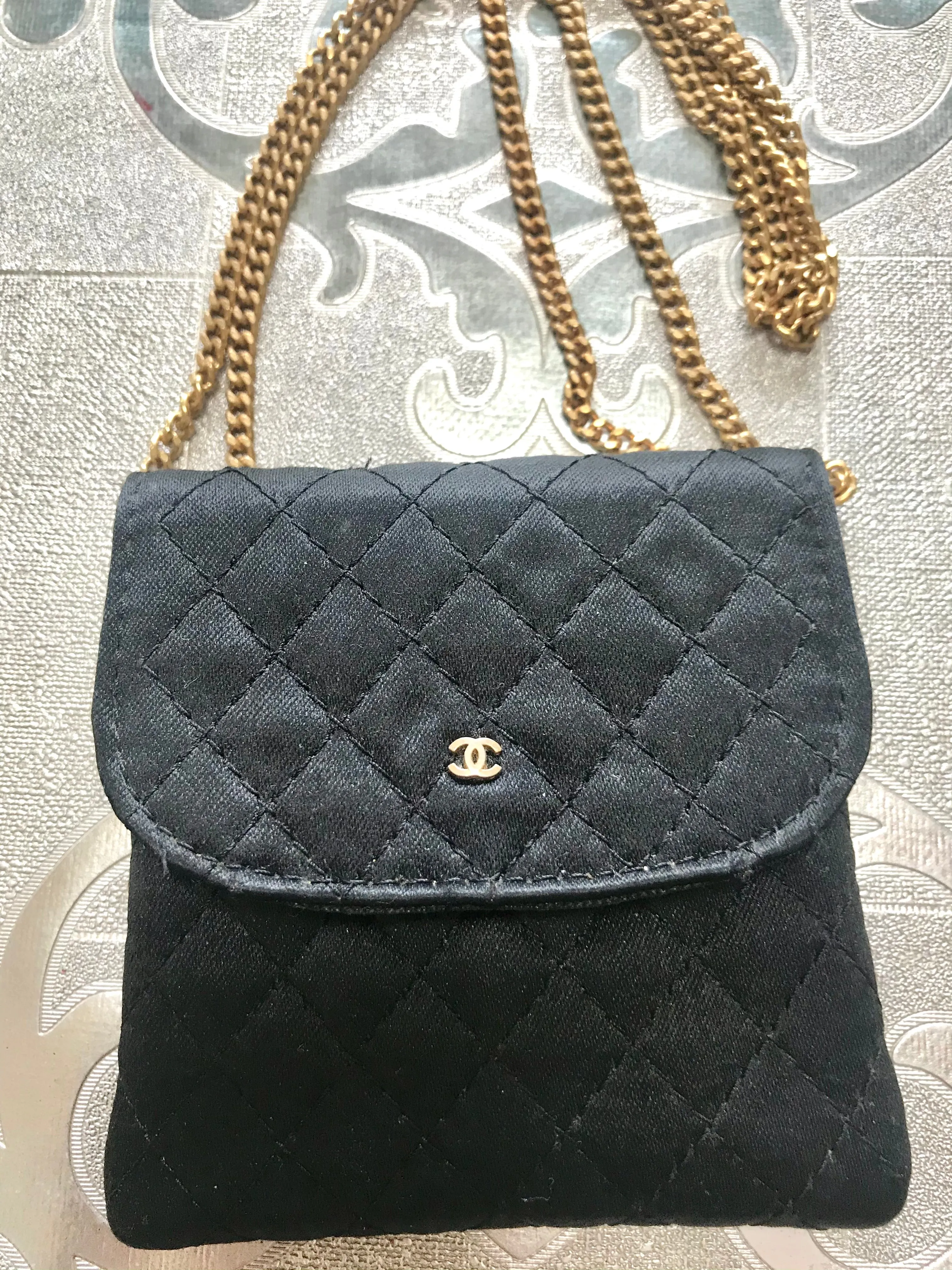 Vintage Chanel black quilted satin fabric mini pouch, coin purse, long necklace with golden chain and CC motif. Fiocci snap. 060516re2