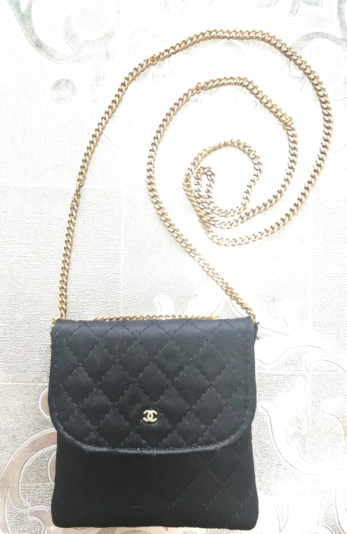 Vintage Chanel black quilted satin fabric mini pouch, coin purse, long necklace with golden chain and CC motif. Fiocci snap. 060516re2