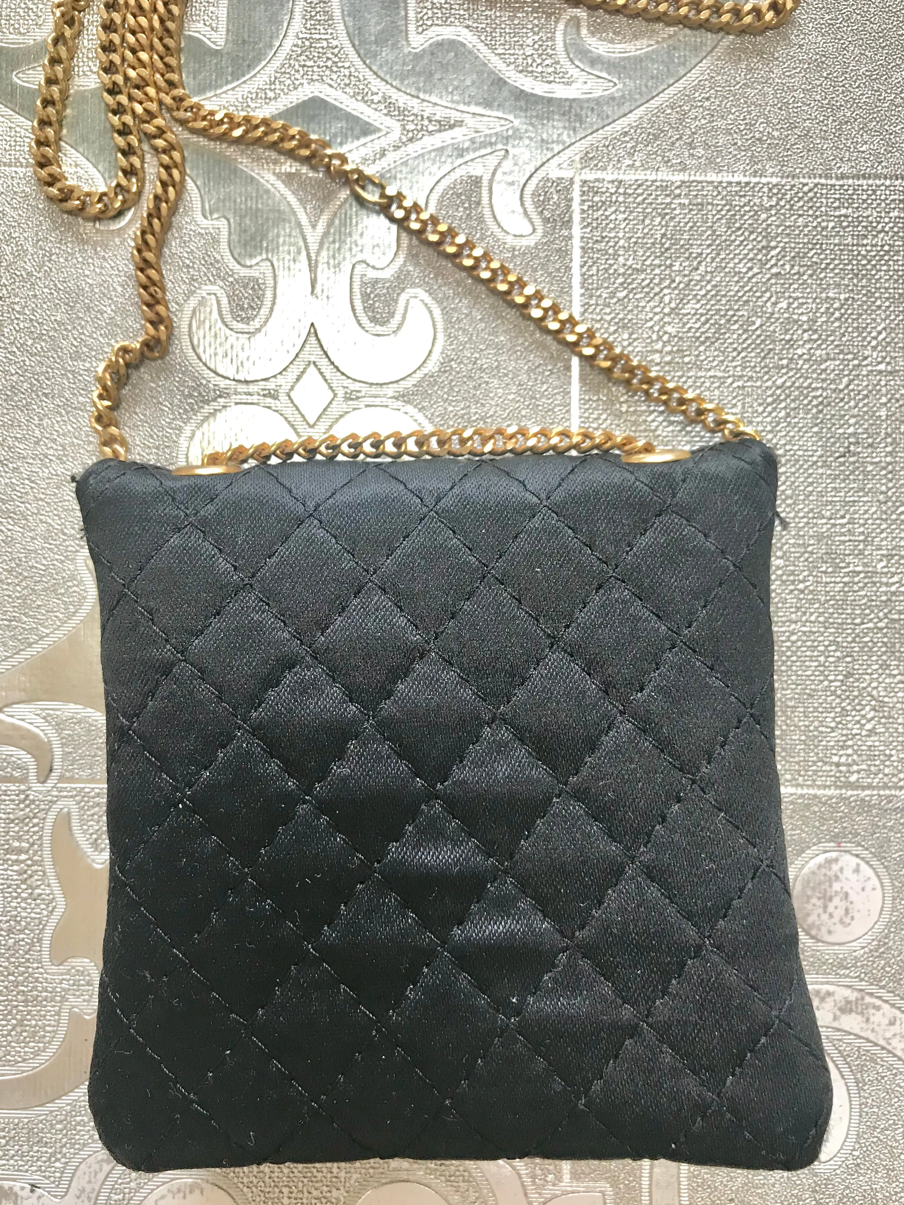 Vintage Chanel black quilted satin fabric mini pouch, coin purse, long necklace with golden chain and CC motif. Fiocci snap. 060516re2